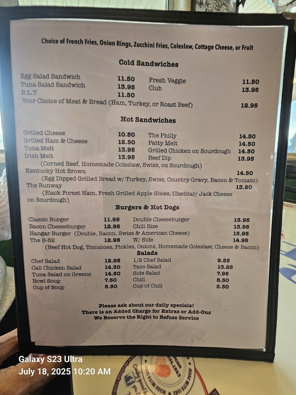 Cafe menu beside a coffee cup